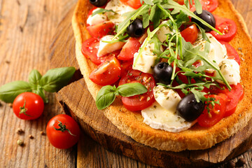 bruschetta with tomato, basil, mozzarella and olive