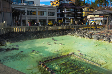 people sightseeing at Yubatake Hotspring with evening light in Gunma ,Japan 