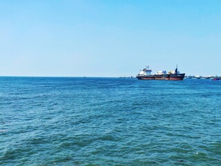 A cargo ship cruising on the Arabian Sea in Kochi, Kerala, India. Kochi Port.