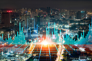 FOREX graph hologram, aerial night panoramic cityscape of Kuala Lumpur. KL is the developed location for stock market researchers in Malaysia, Asia. The concept of fundamental analysis.