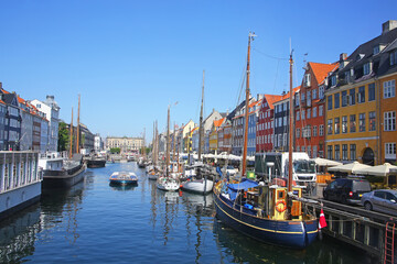 Fototapeta premium View of Nyhavn which is a Historic 17th-century waterfront with wooden ships, canal, colourful buildings and entertainment district in Copenhagen, Denmark.