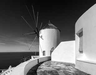 Old mills and courtyards of the white city of Oia on the island of Santorini. Greece.