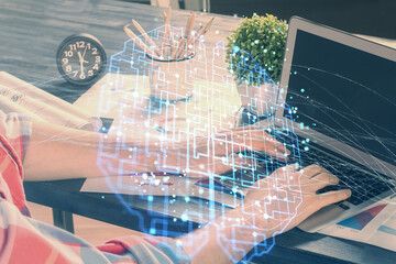 Man with computer background with brain theme hologram. Concept of brainstorm. Double exposure.