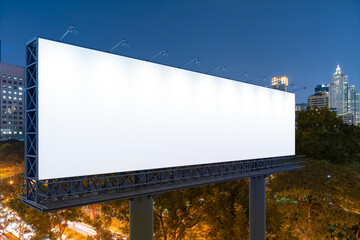 Blank white road billboard with Bangkok cityscape background at night time. Street advertising poster, mock up, 3D rendering. Side view. The concept of marketing communication to sell idea.
