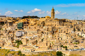 Obraz premium It's Panoramic view of Matera, Puglia, Italy. The Sassi and the Park of the Rupestrian Churches of Matera. UNESCO World Heritage site