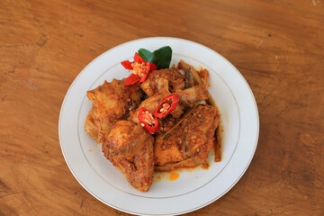Photos of chicken food cooked spicy and served on a plate