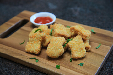 Chicken nuggets serve with saur on wooden boards
