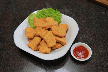 Chicken nuggets serve with saur on wooden boards