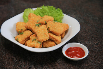 Chicken nuggets serve with saur on wooden boards