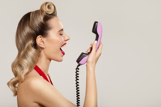 Joyful pin-up girl shout on a retro phone.