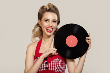 Attractive pin-up girl holding a vinyl record in her hands