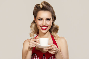 Smiling pin-up girl holding a cup of coffee