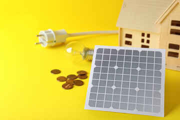 Composition with solar panel on yellow background. Space for text
