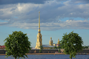 Fototapeta na wymiar View of the city skyline with Peter & Paul Cathedral spires in the background on Hare Island along the Neva River, St Petersburg, Russia