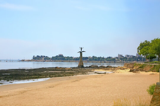 Beautiful empty beach in the center of the city with the monument to the American soilder statue, known as Sammy, Saint Nazaire, France.