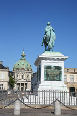 Fototapeta na wymiar Amalienborg Palace Square with a statue of Frederick V on a horse. It is at the centre of the Amalienborg palace, which is the home of the Danish royal family, Copenhagen, Denmark.