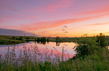 Colorful sky before dawn on a summer morning on the lake