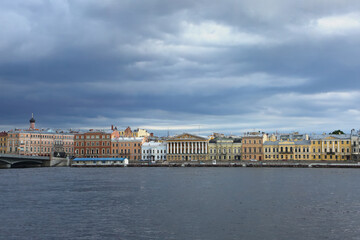 Fototapeta na wymiar View accross the Neva river, which is one of the main waterways of the city, and historic colurful buildings on the other side, St Petersburg, Russia.