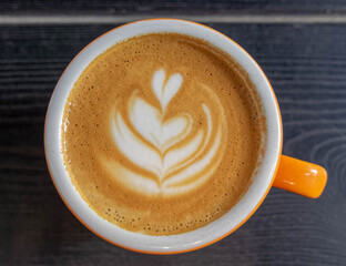 Italian cappuccino coffee cup top view on dark wood table background