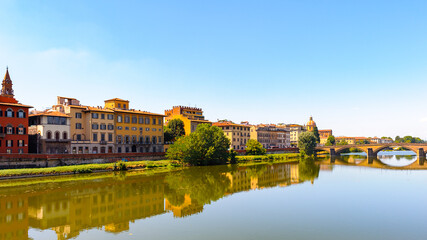 Buildings of different colors over the river Arno in Florence, Italy