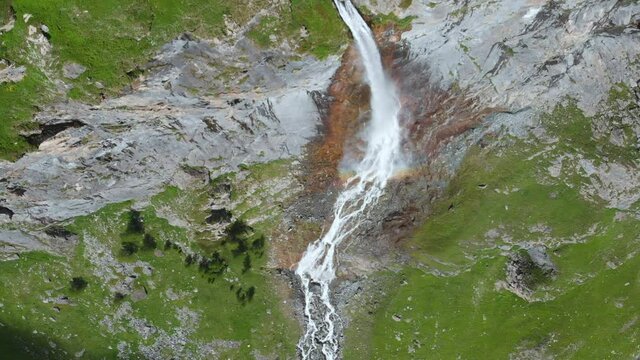 Aerial: drone flying over scenic high waterfall lush green valley and mountain stream on the italian Alps. Tourism destination hiking outdoors activity. Pis waterfall near Torino, Piedmont, Italy