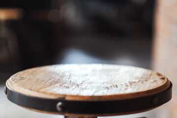 Closeup image of a small wooden table with blurred background