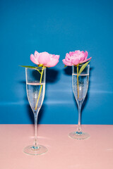 Two glasses of champagne at classic blue background