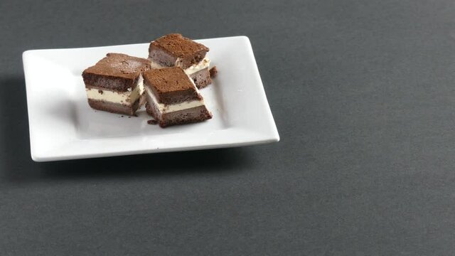 Homemade ice cream sandwich picked up and a bite taken out of it before being placed back on the plate