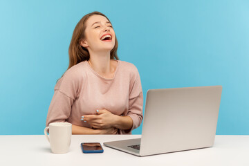 Amused happy woman employee laughing out loud, holding her stomach and being hysterical at crazy...