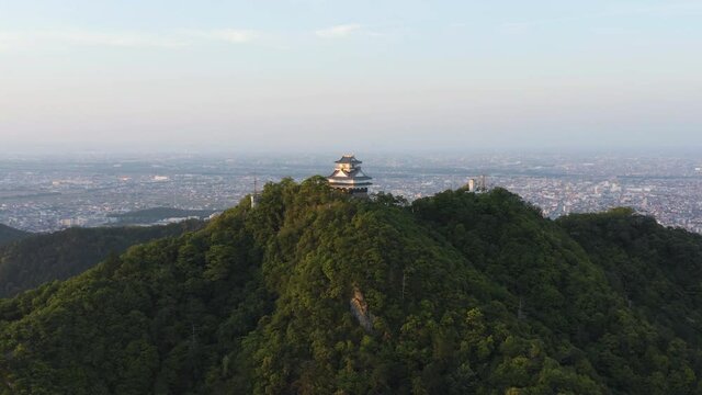 Gifu castle and city in background, Aerial pan shot at sunrise