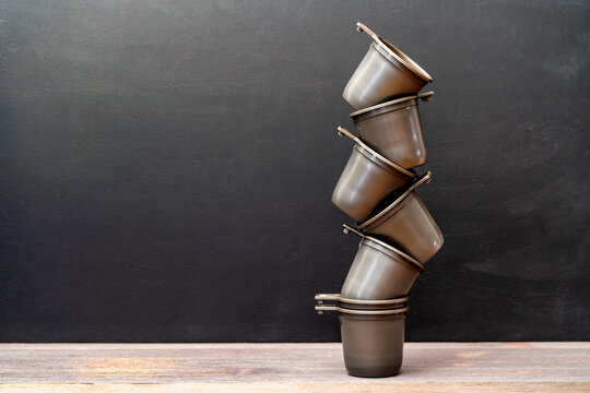 Stack Of Plastic Cups On Chalk Board Background With Copy Space