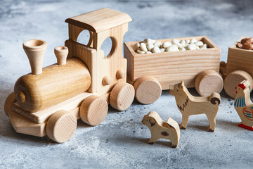 Children's wooden toys. Children wooden  train with wagons. Natural wood construction set. Educational equipment