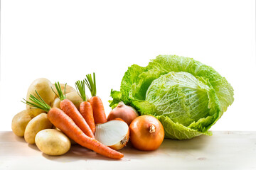 Vegetales y hortalizas , col, zanahorias, patatas y cebollas sobre fondo blanco. Vegetables and...