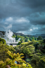 Fototapeta premium Dramatic winter sky over geothermal zone in mountains near Rotorua