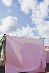 clothes hanging in the sun on the terrace. Sky with sun and clouds in summer