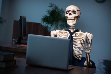 Young male employee working in the office night time