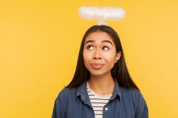 I'm angel! Portrait of thoughtful girl looking at nimbus over her head, fantasizing about paradise,...