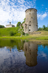 Ancient Gremyachaya Tower and Cosmodamianskaya Church on a June afternoon. Pskov, Russia