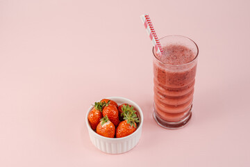 One Red Strawberry Smoothie Cocktail with Bunch of Strawberries Standing on the Table