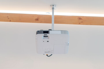 the projector is hanged on to seminar hall ceiling. It's standing by for lighting out the...