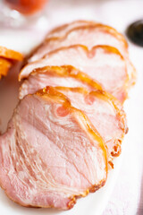 Whole smoked slab bacon sliced and served on plate. Selective focus. Shallow depth of field.