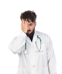 Fototapeta premium Young doctor with beard wearing a medical gown