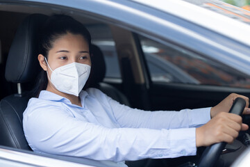 Woman is wearing masks before driving every time to prevent the corona virus.