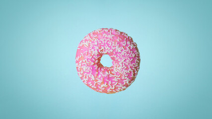 Pink donut (doughnut) on a blue background. Holiday and sweets, baking for children, sugar concept