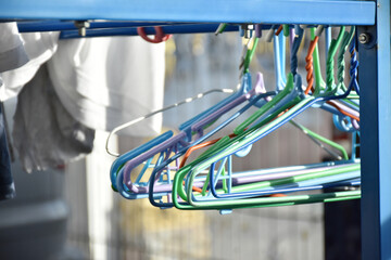 Multi-color of steel clothes hanger group are hang on clothesline. Laundry cloth concept.