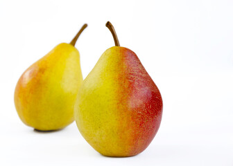 pear fruit, yellow fruits with red sides on a light background