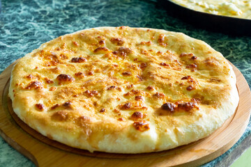 Traditional Georgian bread - khachapuri on the wooden board