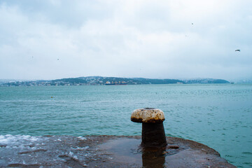 Bollard in foreground, seascape. Istanbul Bosphorus and bollard sea.