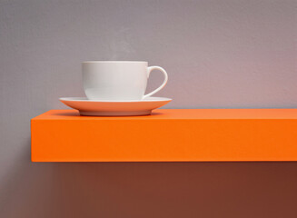 Cup of coffee on orange table
