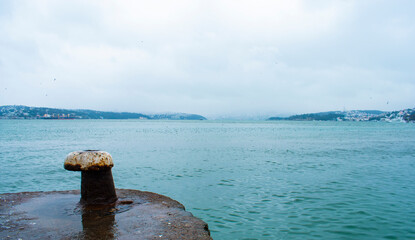 Bollard in foreground, seascape. Istanbul Bosphorus and bollard sea.